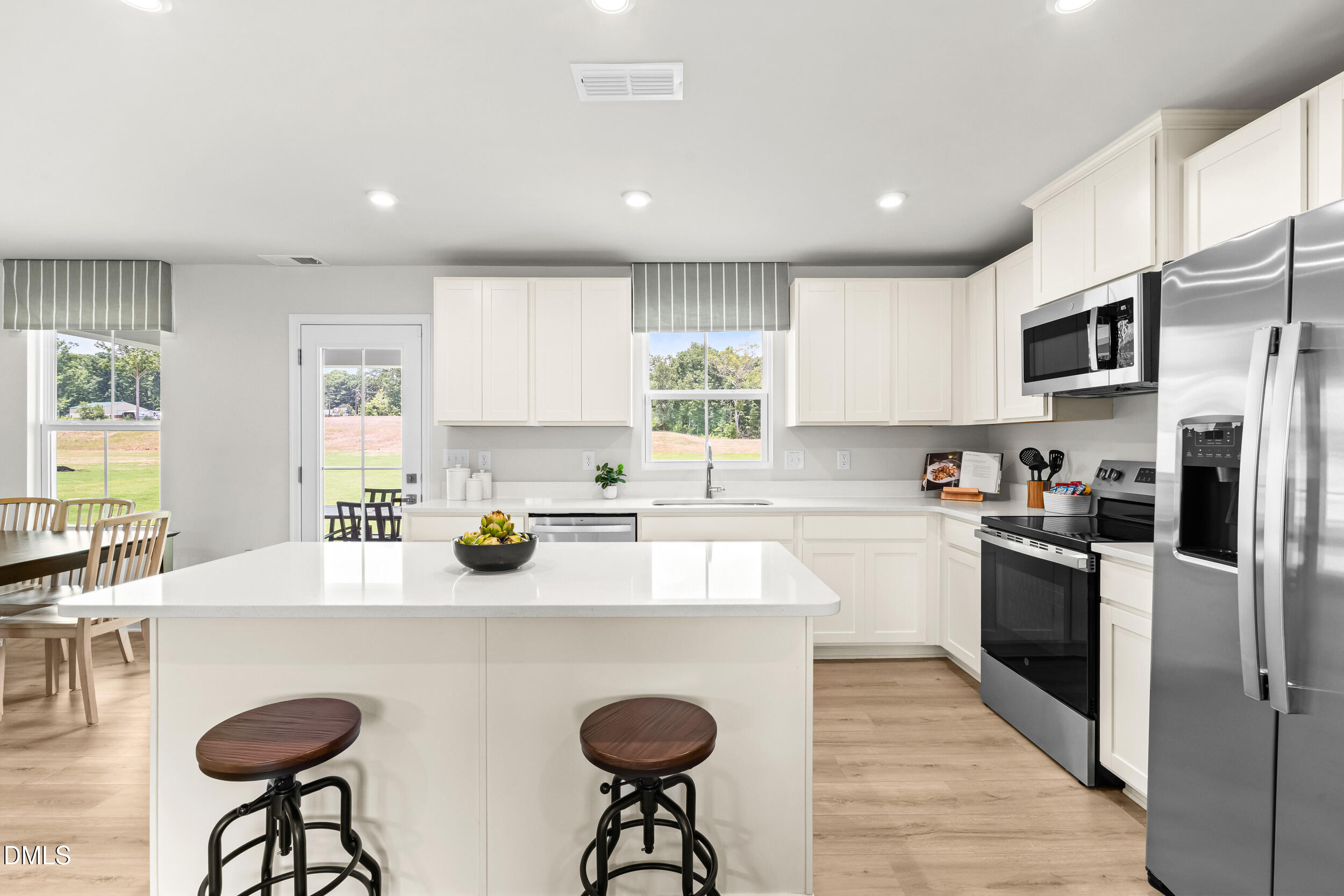 197 Brook Bawn Road Wendell, NC 27591 - Photo 2 of 33 a kitchen with stainless steel appliances granite countertop a sink a stove and a refrigerator