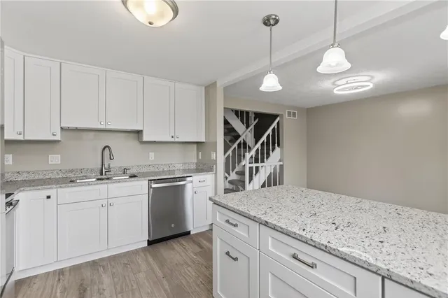 a kitchen with a sink stainless steel appliances and cabinets