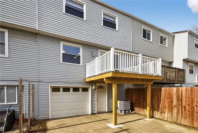 a view of a house with wooden fence