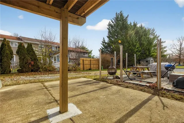 a view of a house with backyard and sitting area