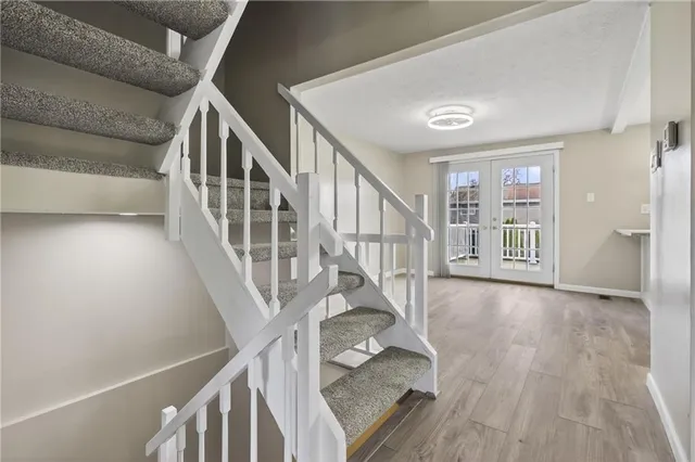 a view of an entryway with wooden floor
