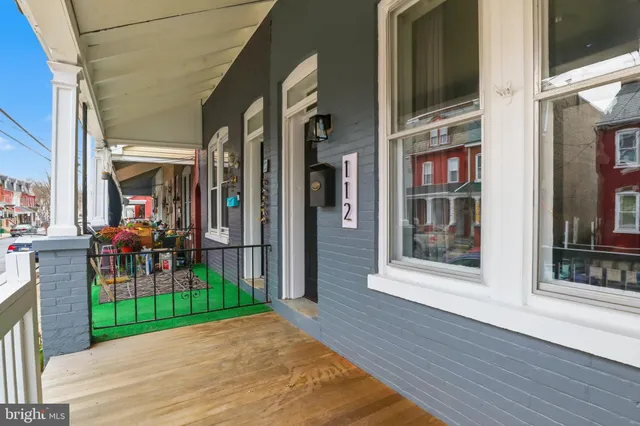 a view of a porch with a table and chairs