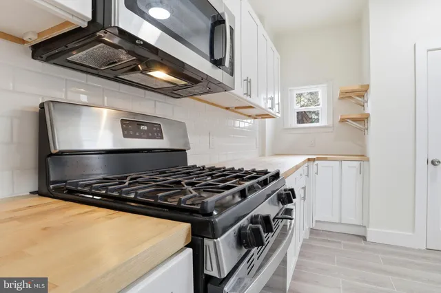a kitchen with stainless steel appliances granite countertop a stove and a refrigerator