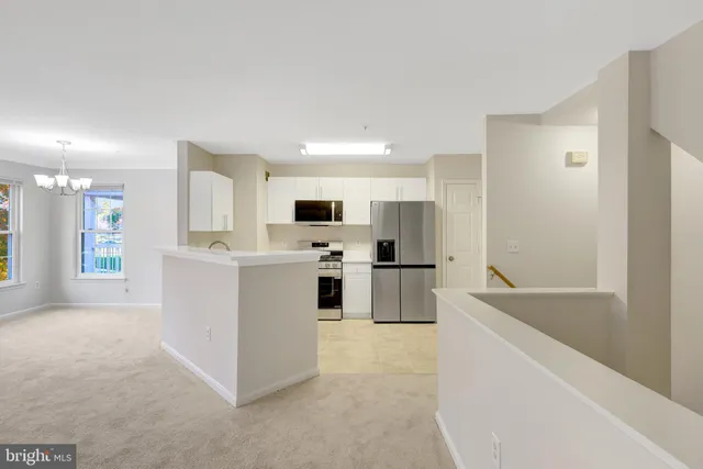 a large white kitchen with cabinets and stainless steel appliances