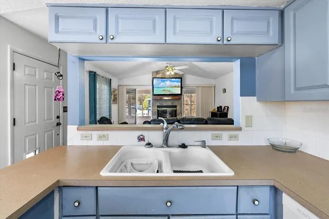 a kitchen with a sink cabinets and window