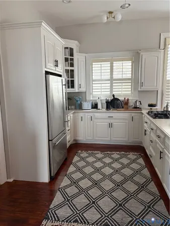 a kitchen with granite countertop a refrigerator and a sink