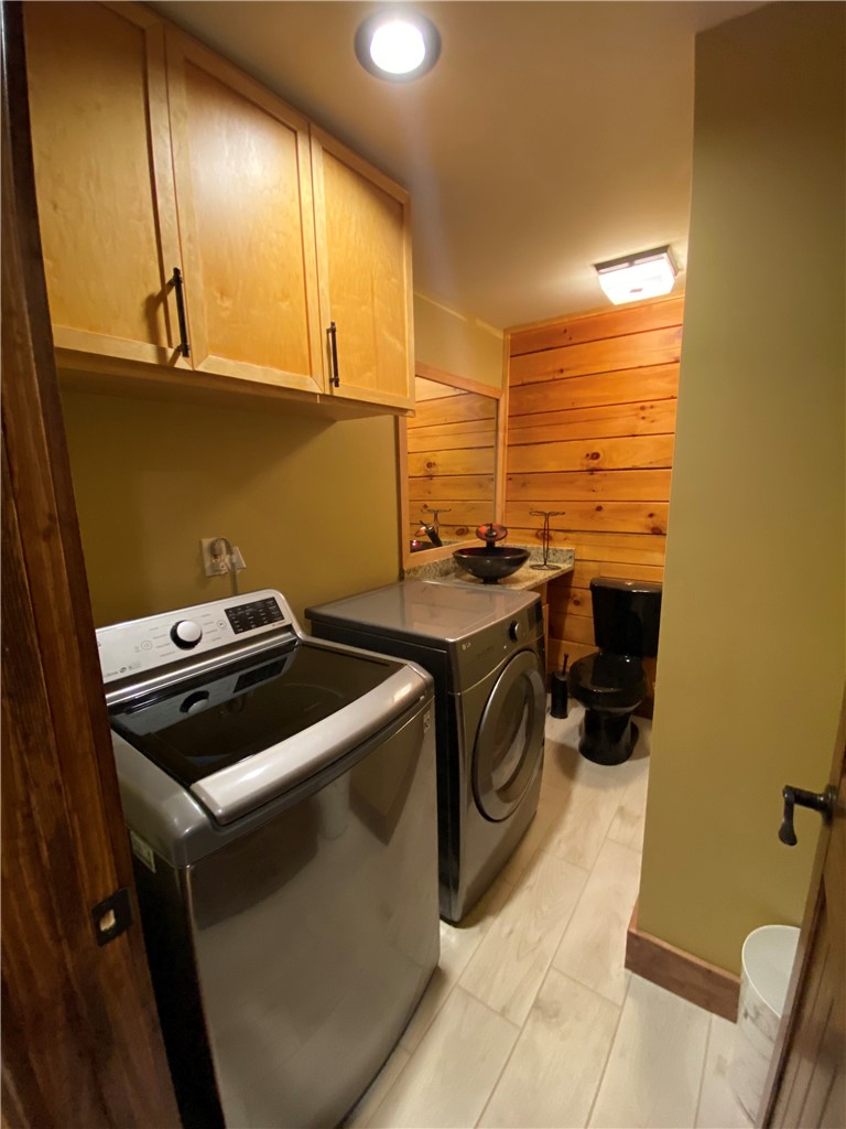 128 McAlister Road West Union, SC 29696 - Photo 15 of 40 Functional laundry space featuring modern appliances and natural wood accents.