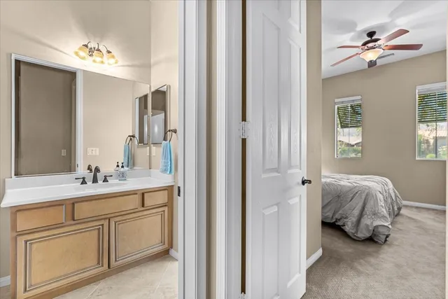 a en suite bathroom with a double vanity sink and a mirror