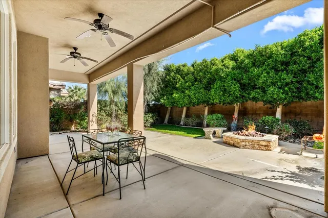 a view of a patio with a table and chairs and potted plants