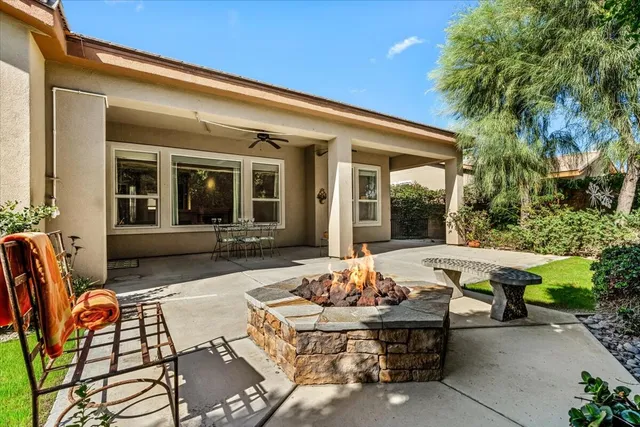 a view of a patio with couches table and chairs and potted plants