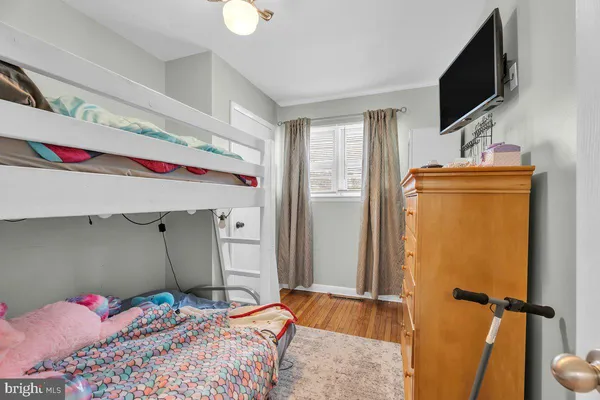 a bedroom with a bed and flat screen tv