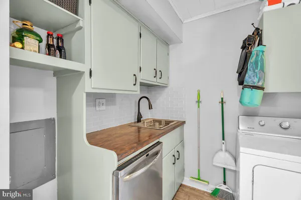 a kitchen with a sink and a stove top oven