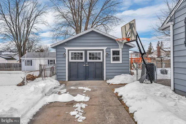 a view of a house with a yard covered in snow