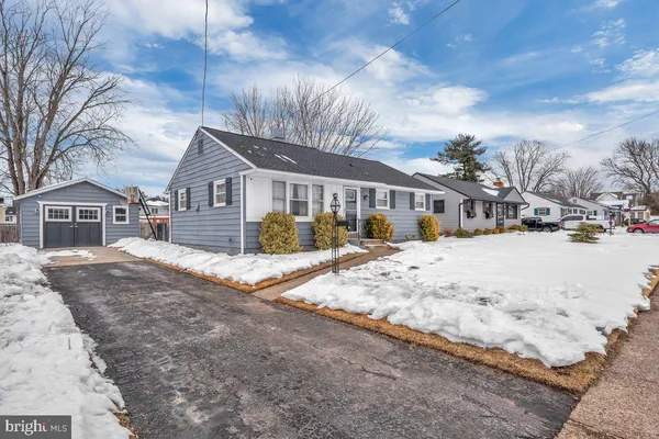 a view of residential houses with snow on the road