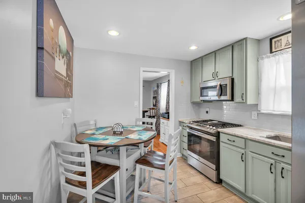 a kitchen that has a table and chairs in it