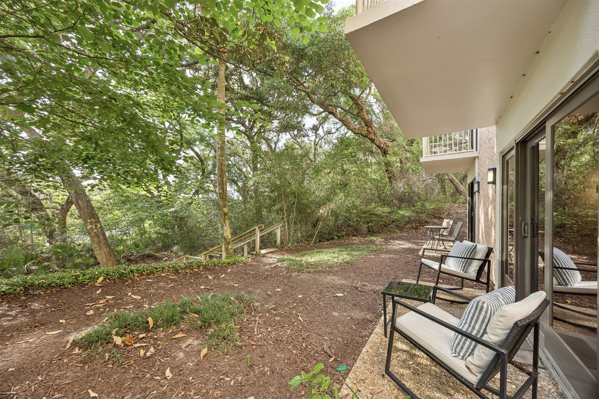 2014 Beachwood Road, Unit 2014 Amelia Island, FL 32034 - Photo 2 of 36 a view of a patio with table and chairs and couches