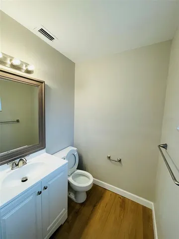 a bathroom with a sink mirror and toilet