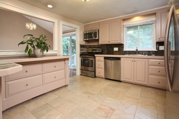 152 Littlefield Road Boxborough, MA 01719 - Photo 5 of 10 a kitchen with white cabinets stainless steel appliances and a sink