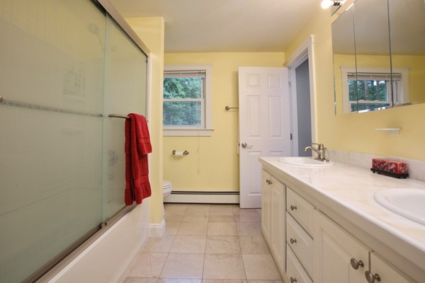 152 Littlefield Road Boxborough, MA 01719 - Photo 7 of 10 a spacious bathroom with a granite countertop sink a mirror and a bathtub