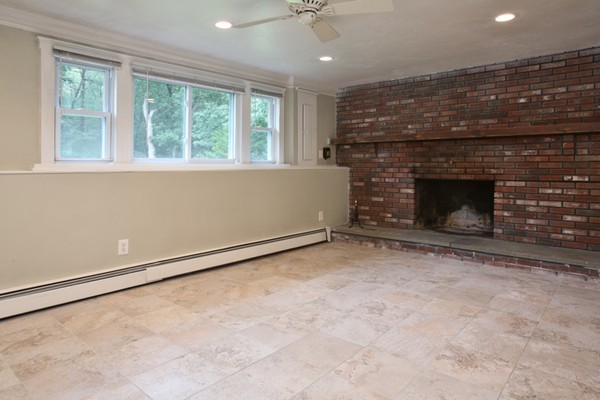 152 Littlefield Road Boxborough, MA 01719 - Photo 8 of 10 an empty room with windows and fireplace