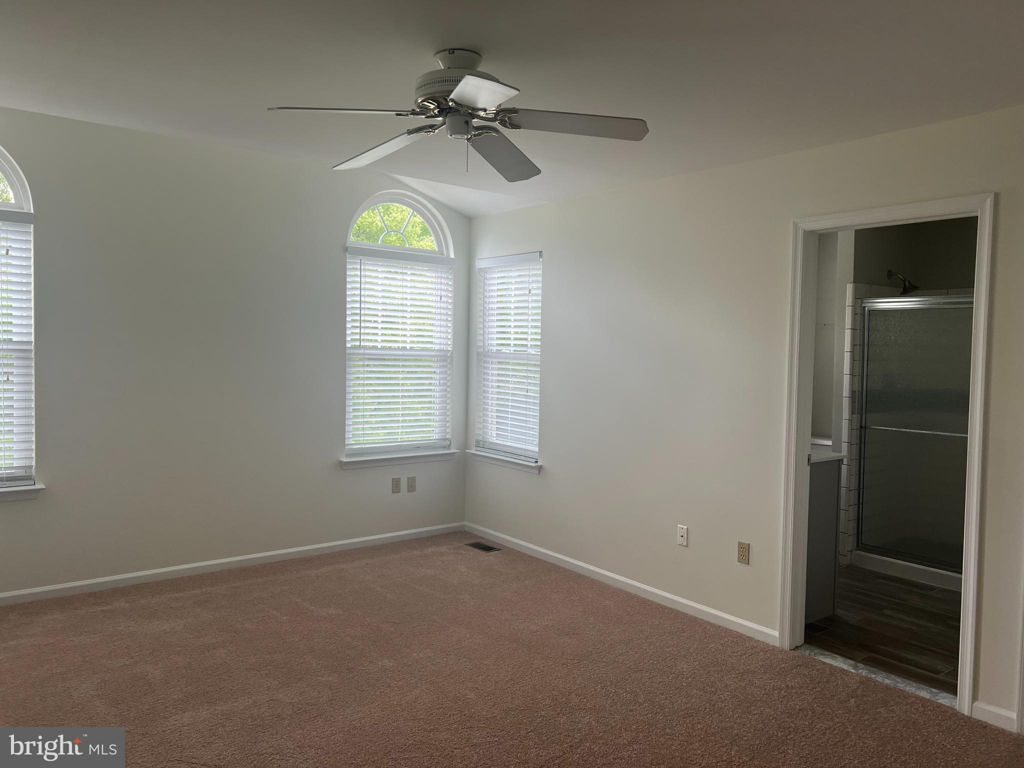 148 Galway Circle Chalfont, PA 18914 - Photo 12 of 23 an empty room with windows and chandelier fan