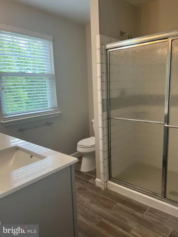 a bathroom with a shower and a toilet