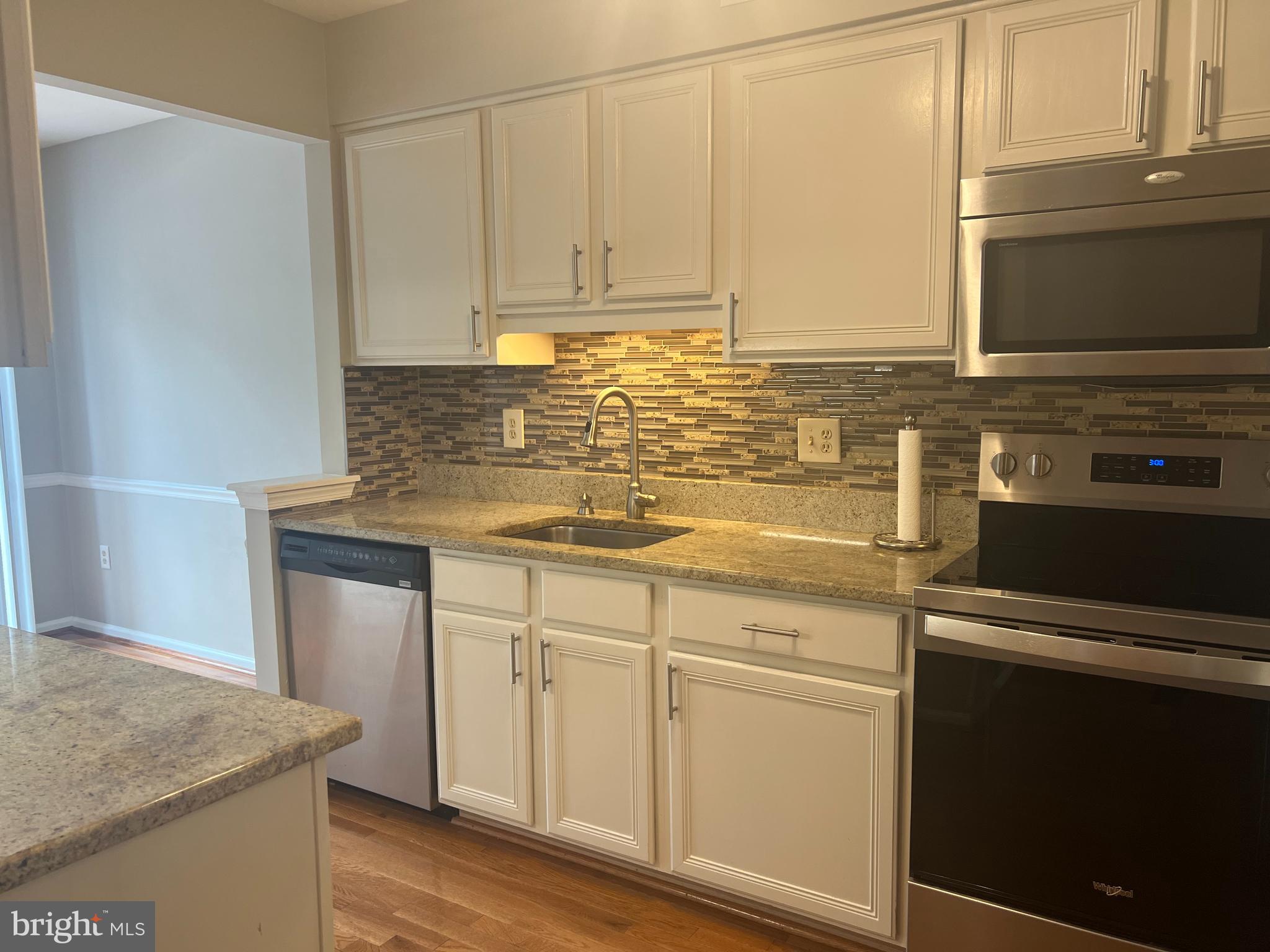 148 Galway Circle Chalfont, PA 18914 - Photo 5 of 23 a kitchen with granite countertop white cabinets and white appliances