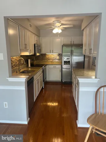 a kitchen with a sink cabinets and stainless steel appliances