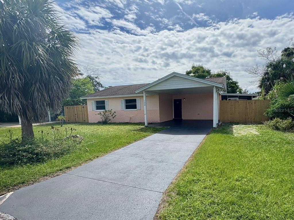 a front view of house with yard and green space