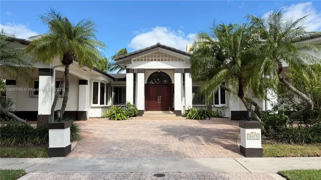a front view of a house with a garden