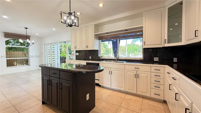 a kitchen with stainless steel appliances granite countertop a sink a stove and a microwave