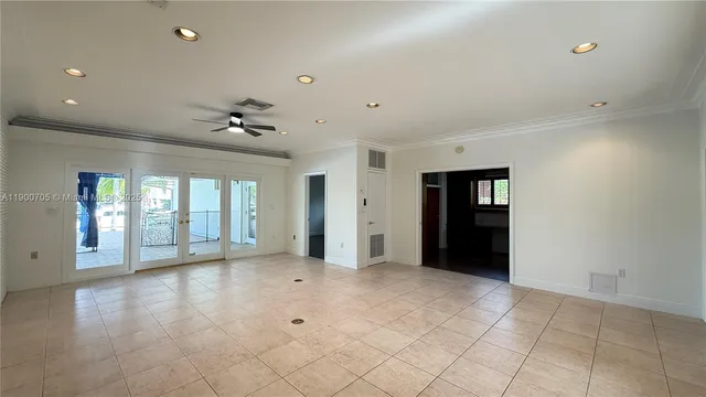a view of an empty room with potted plants