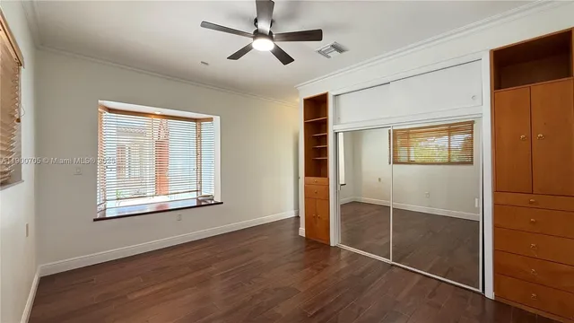 a bathroom with a granite countertop sink a mirror and a shower