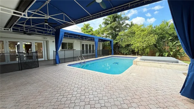 a view of swimming pool with a patio