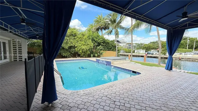 a view of a patio with a table and chairs under an umbrella