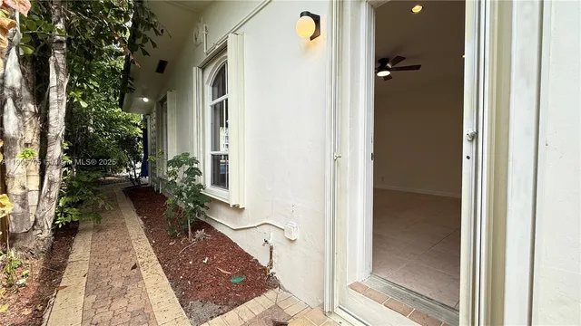 an aerial view of a city with lots of residential buildings ocean and mountain view in back