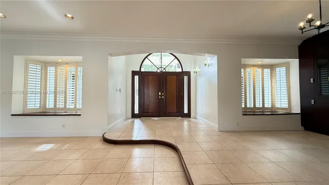 a large kitchen with stainless steel appliances kitchen island granite countertop a refrigerator and cabinets