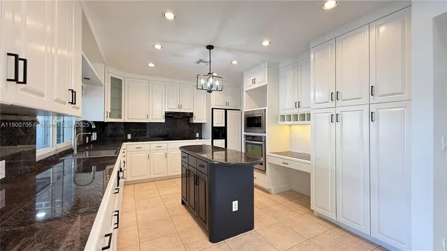 a kitchen with stainless steel appliances granite countertop a sink and a stove