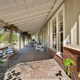 a view of a porch with chairs and backyard