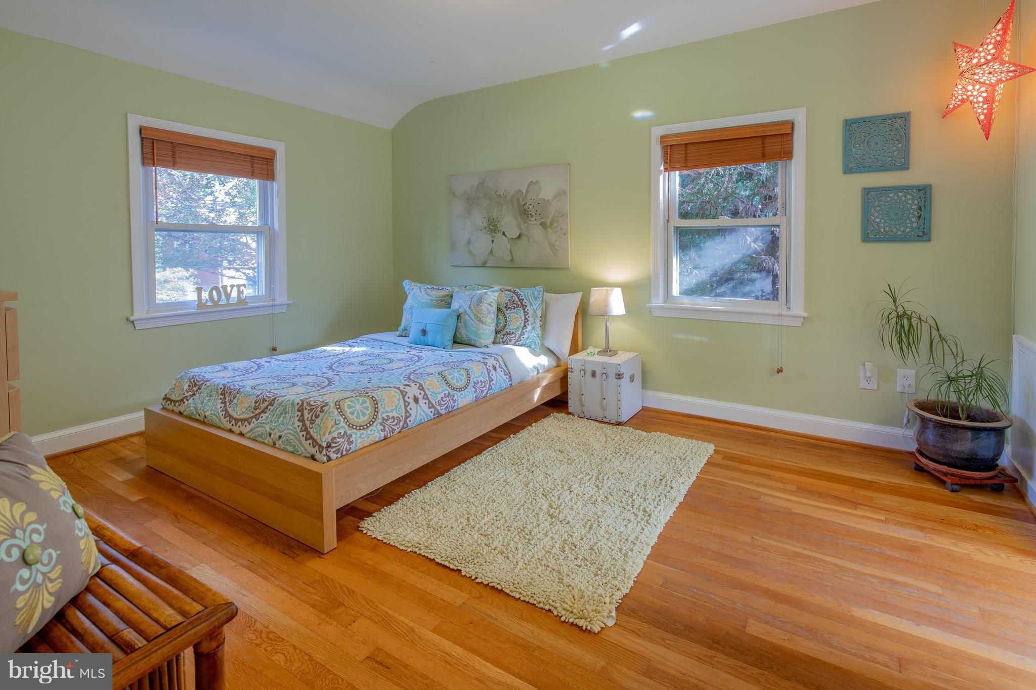 9522 Saybrook Avenue Silver Spring, MD 20901 - Photo 22 of 29 a bedroom with a bed and wooden floor