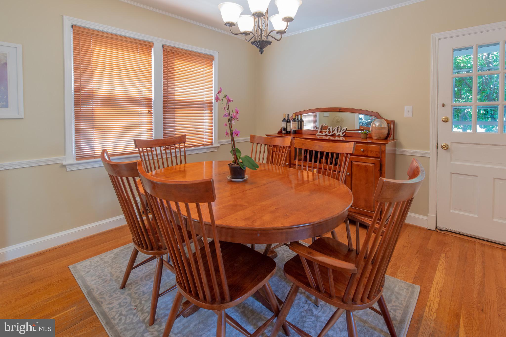 9522 Saybrook Avenue Silver Spring, MD 20901 - Photo 5 of 29 a view of a dining room with furniture a chandelier and wooden floor