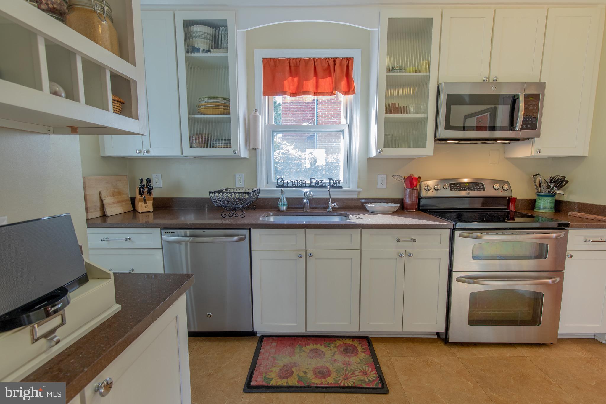 9522 Saybrook Avenue Silver Spring, MD 20901 - Photo 8 of 29 a kitchen with stainless steel appliances granite countertop a stove a sink and a microwave