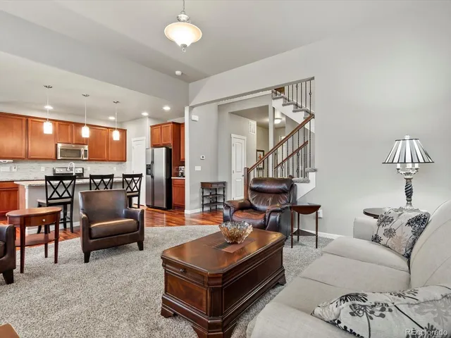 a living room with furniture and a chandelier