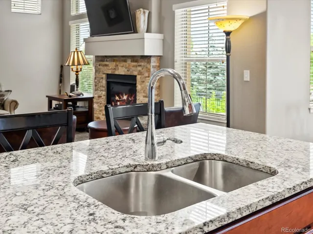 a view of kitchen and living room with a fireplace