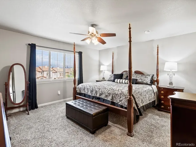 a bedroom with a bed wooden floor and window