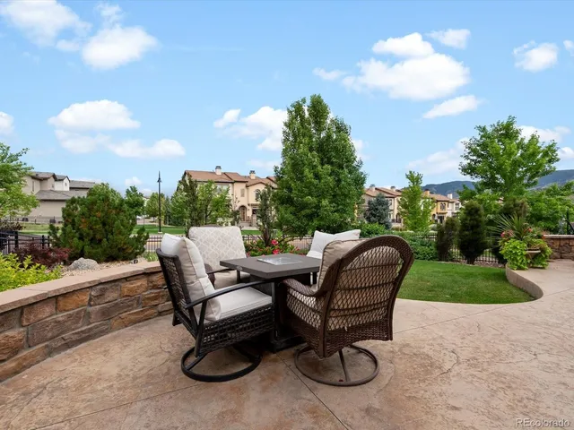 a view of a patio with couches and a potted plant on a table and chairs