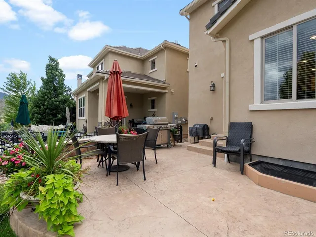 a front view of a house with patio and garden