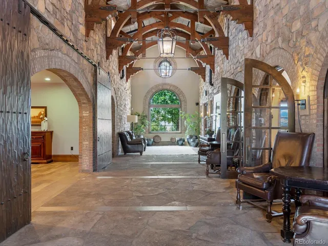 a living room with furniture and a floor to ceiling window