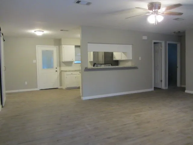 a view of a kitchen with microwave and stove top oven