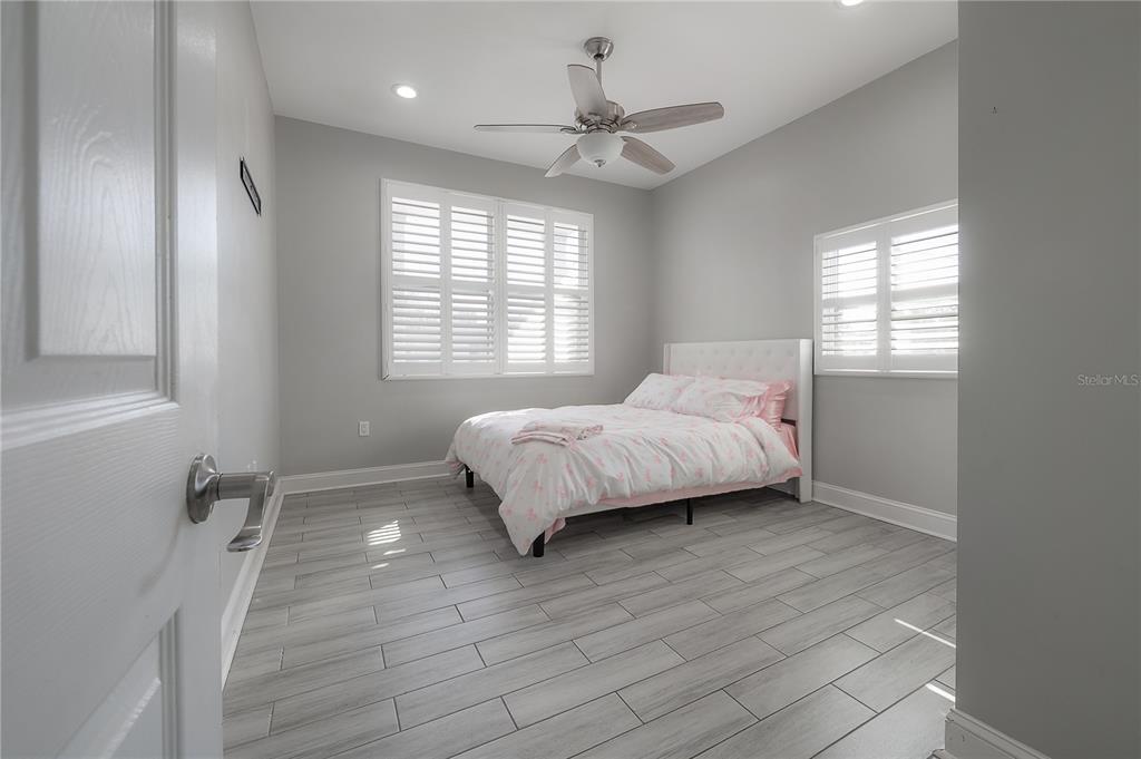 2341 West Chestnut Street Tampa, FL 33607 - Photo 24 of 42 a spacious bedroom with a bed and a window